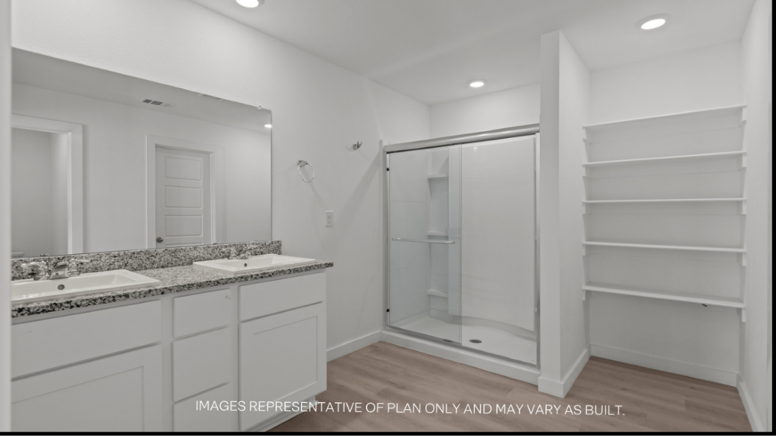 Private attached primary bathroom with built in vanity and luxurious shower