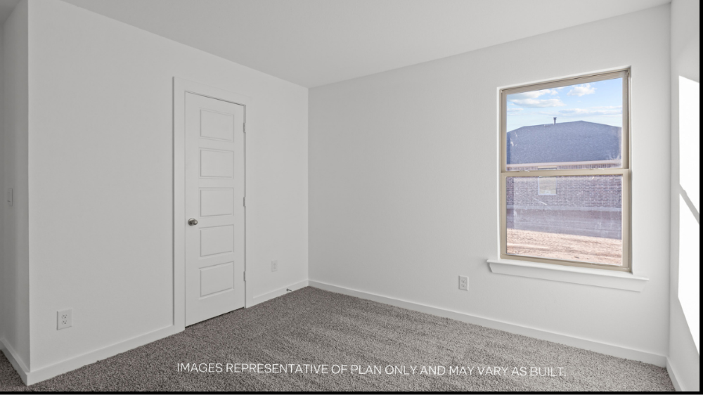 Guest bedroom 2 with side window and plush carpet floor