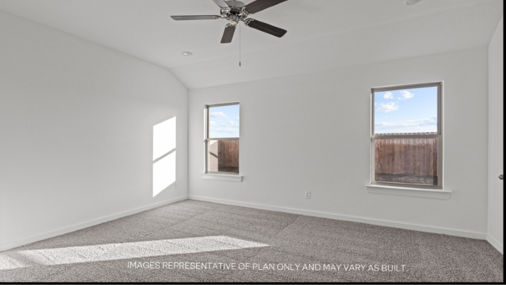Primary bedroom with plush carpet floors and light allowing double windows