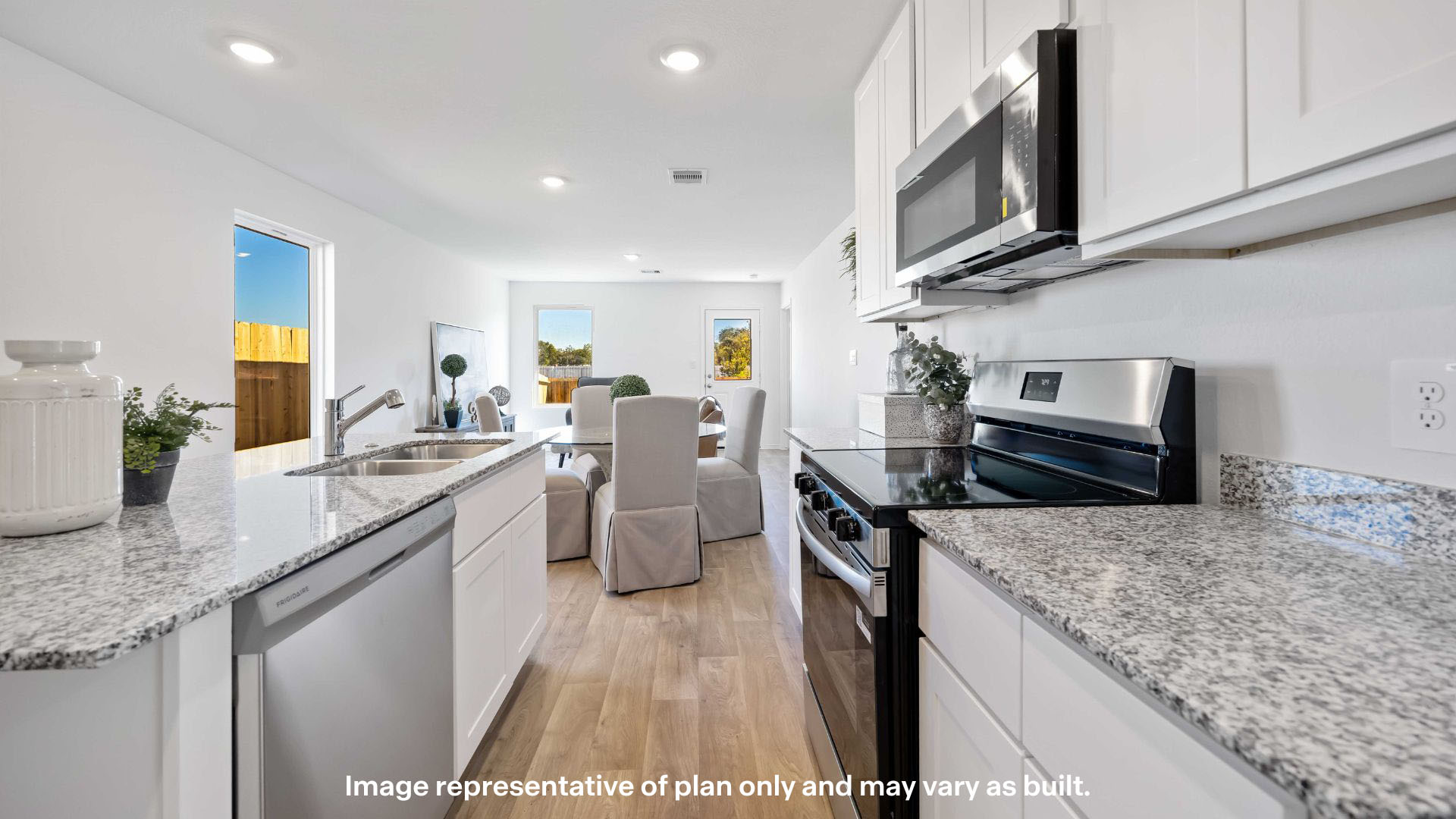 Open concept kitchen with stainless steel appliances, shaker style cabinets, and elevated finishes
