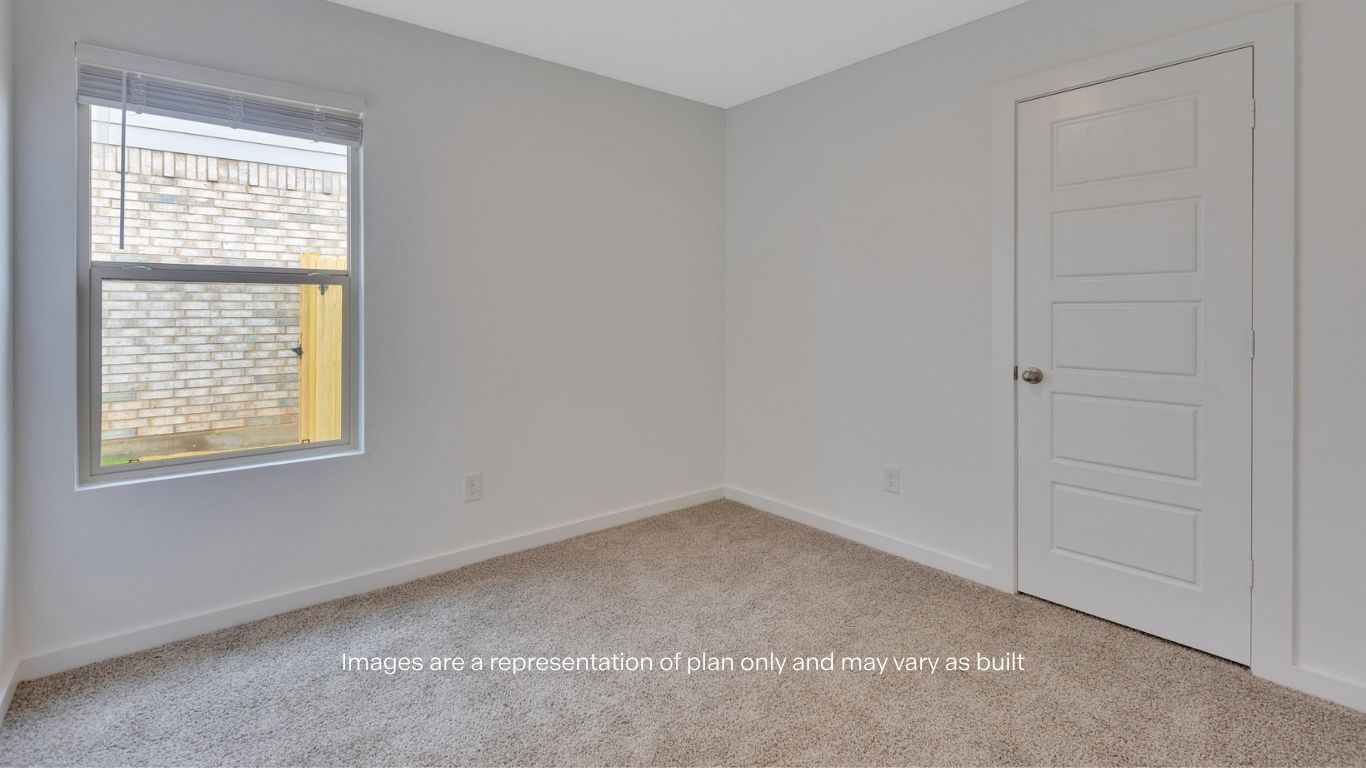 Guest bedroom with side window and plush carpet floor