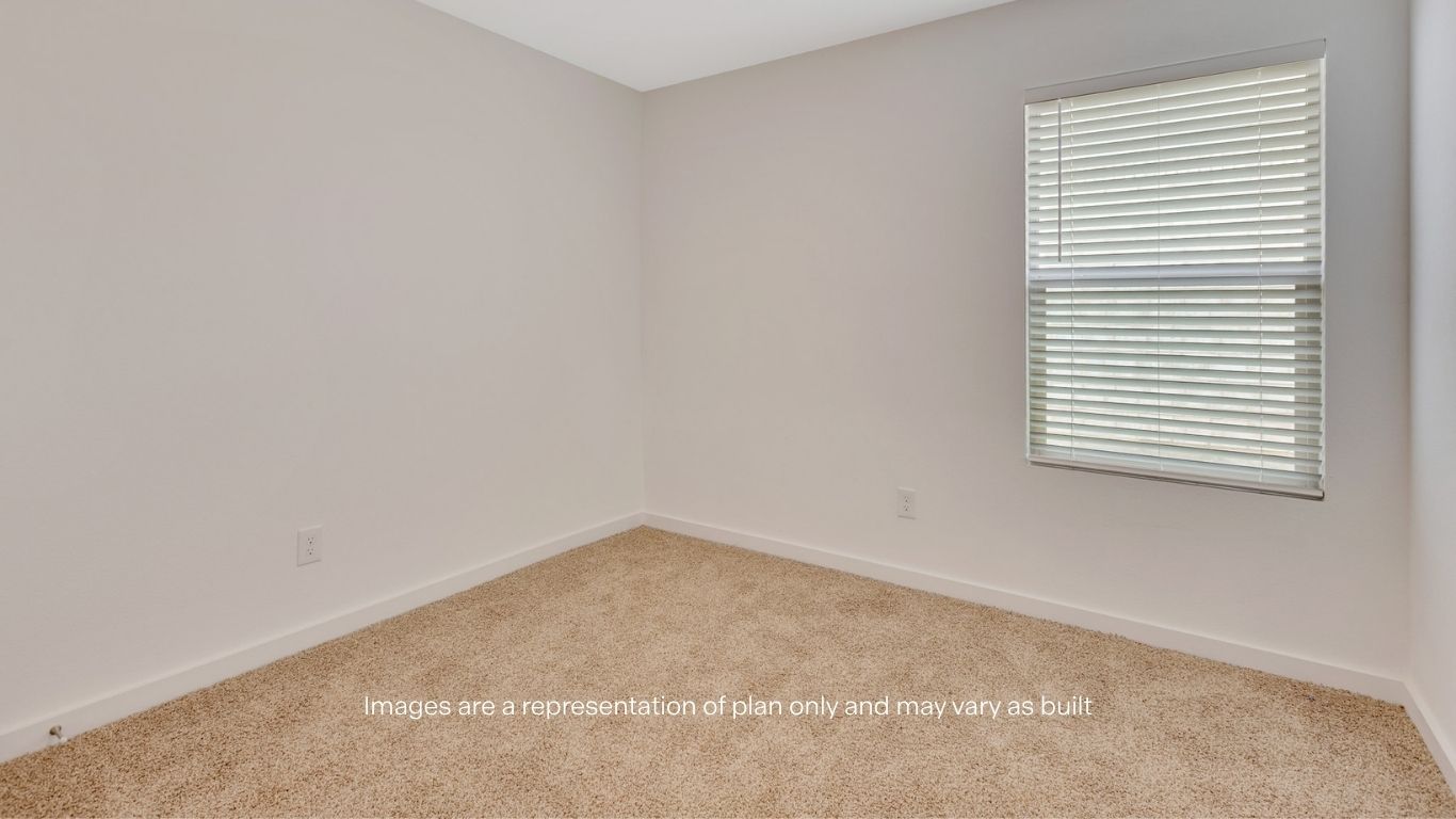 Guest bedroom with side window and plush carpet floor