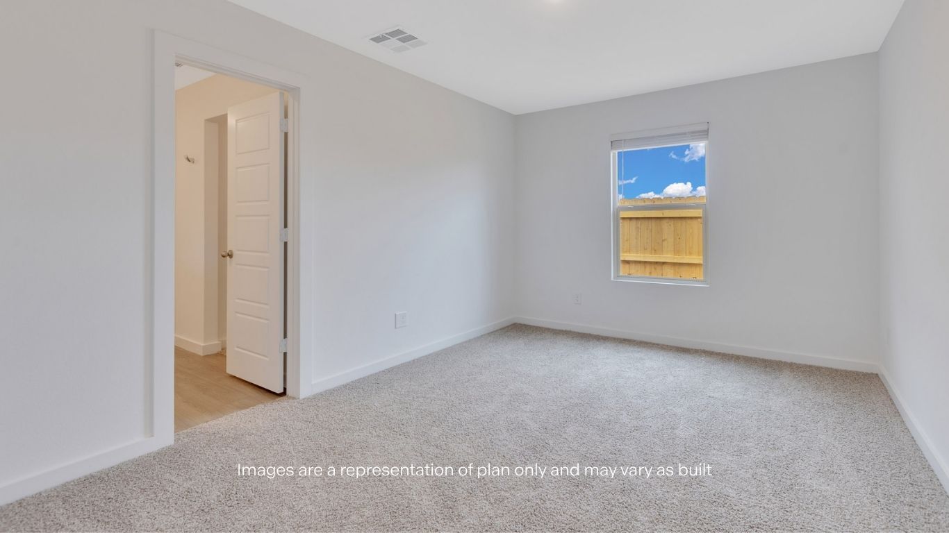 Primary bedroom with private attached bathroom and walk-in closet