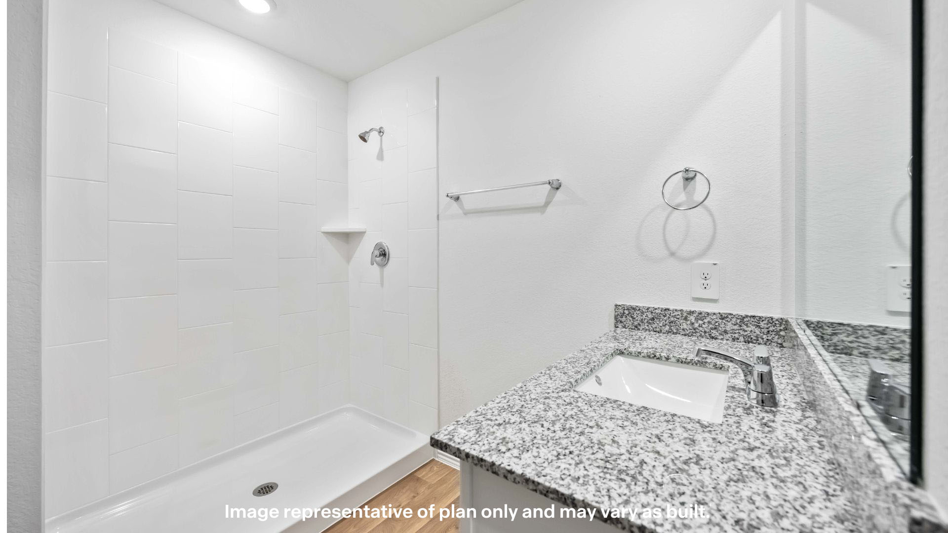 Private attached primary bathroom with built in vanity and luxurious shower