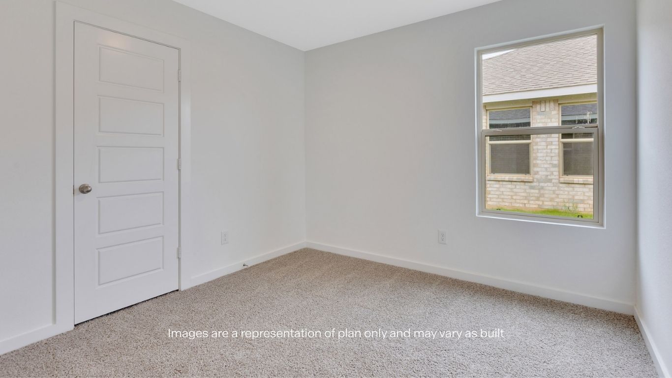 Guest bedroom with side window and plush carpet floor