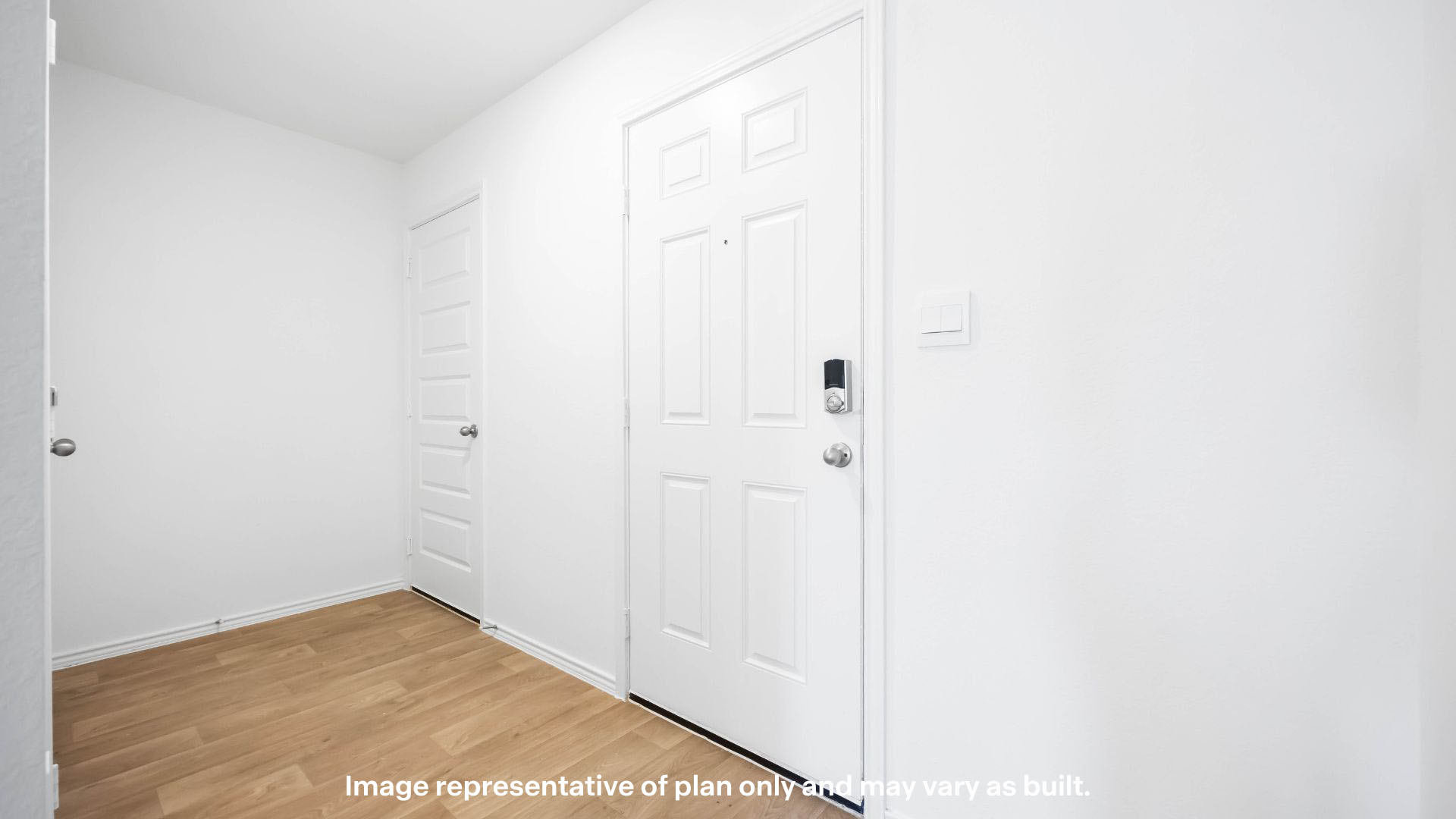 Entrance foyer with coat closet and laundry closet