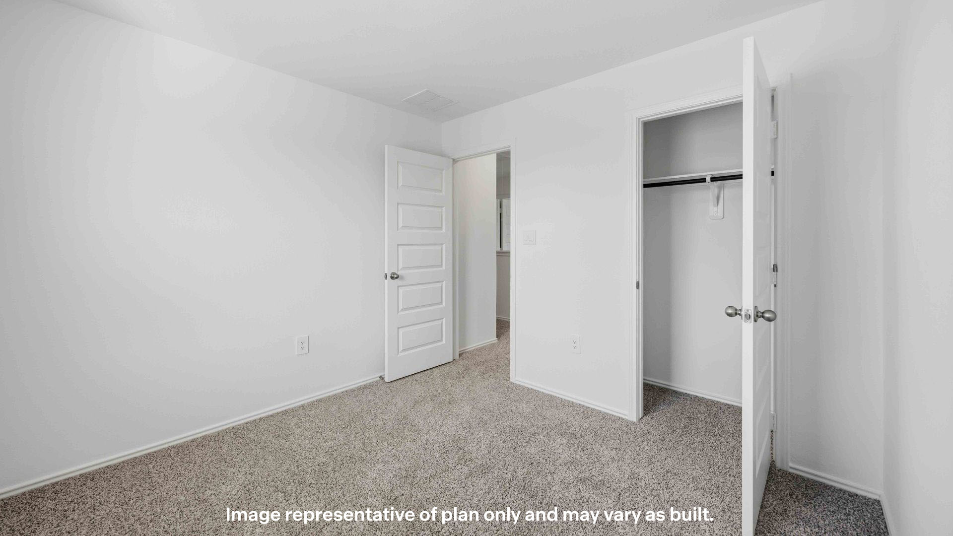 Guest bedroom 1 with plush carpet floors and spacious closet