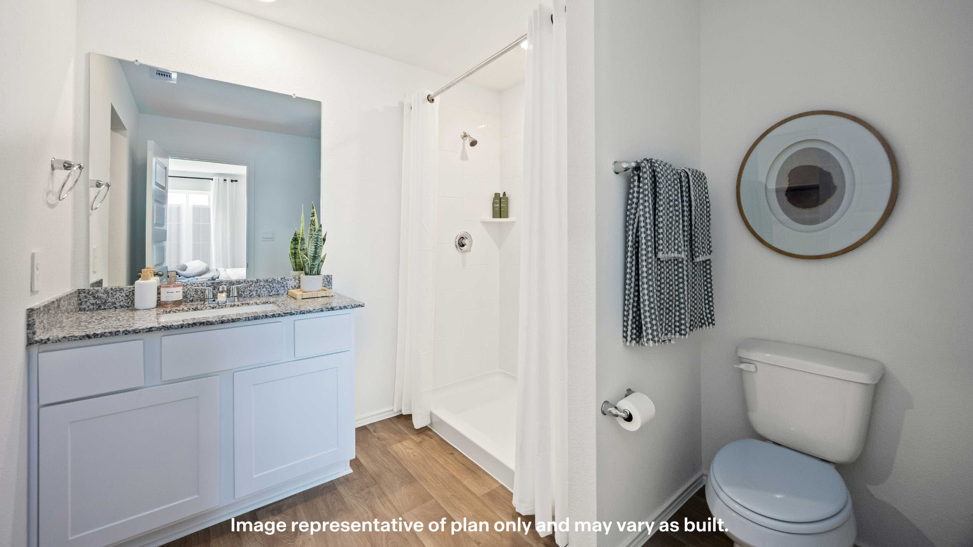 Private attached primary bathroom with built in vanity and luxurious shower