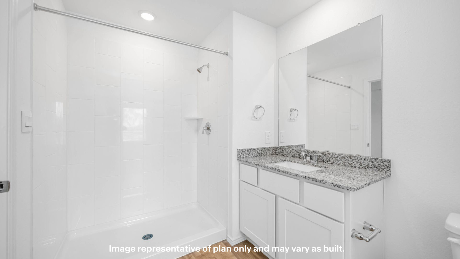 Private attached primary bathroom with built in vanity and luxurious shower