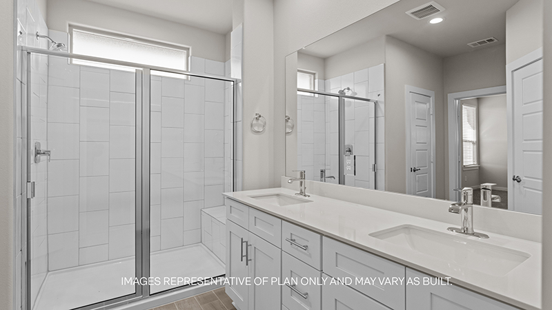 Private attached primary bathroom with built in vanity and luxurious shower