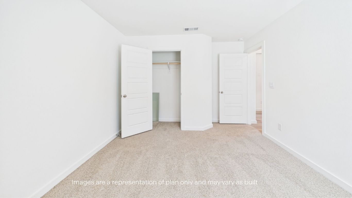 Guest bedroom with side window and plush carpet
