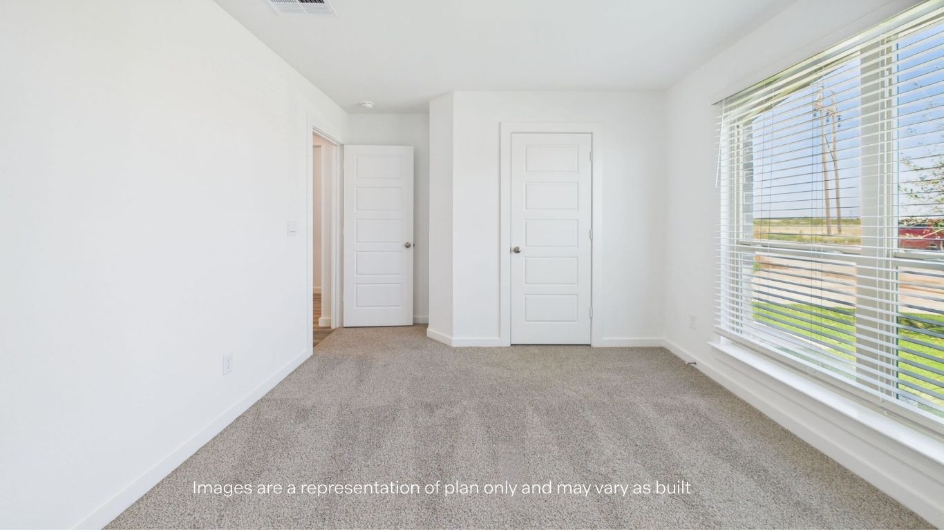 Guest bedroom with front window and plush carpet