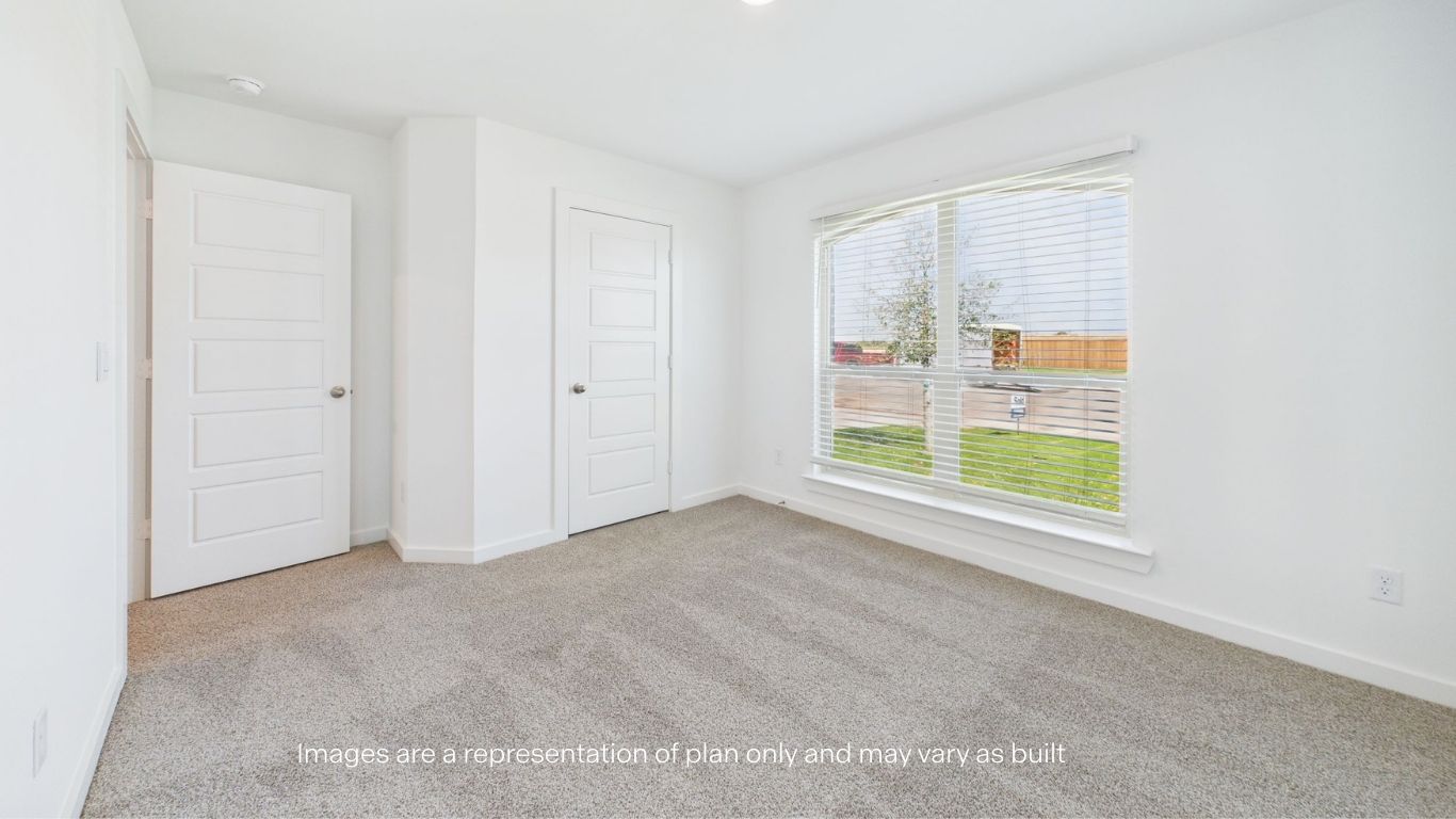 Guest bedroom with front window and plush carpet