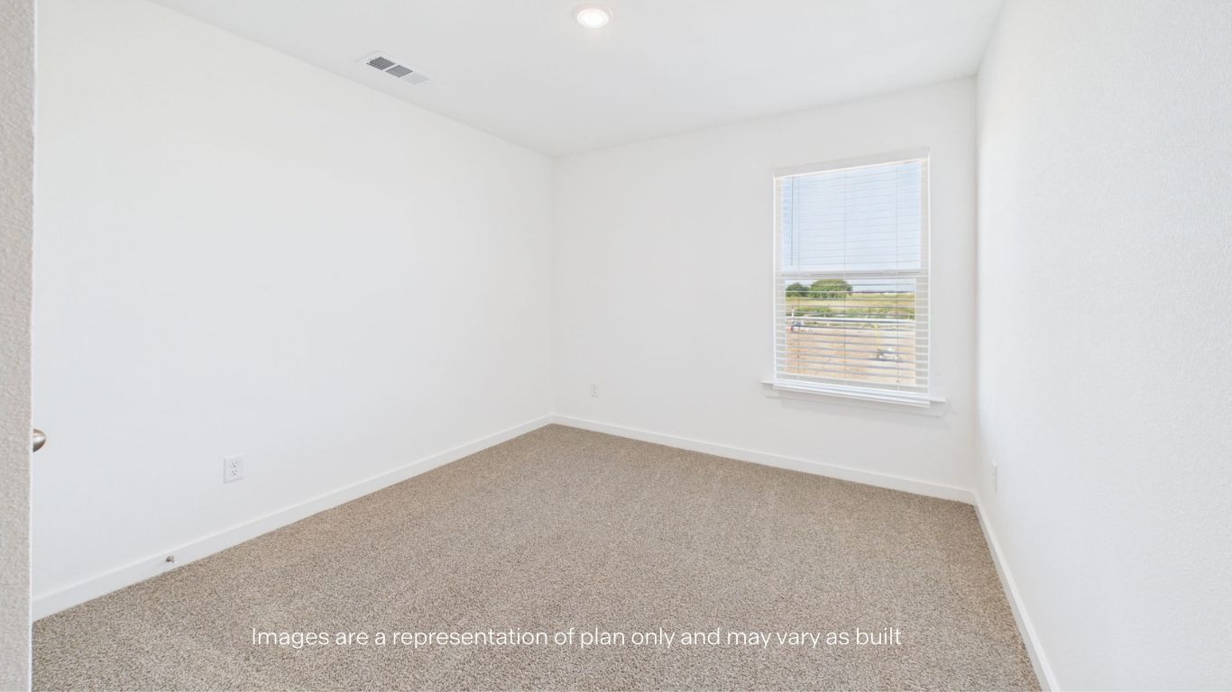 Guest bedroom with side window and plush carpet floor