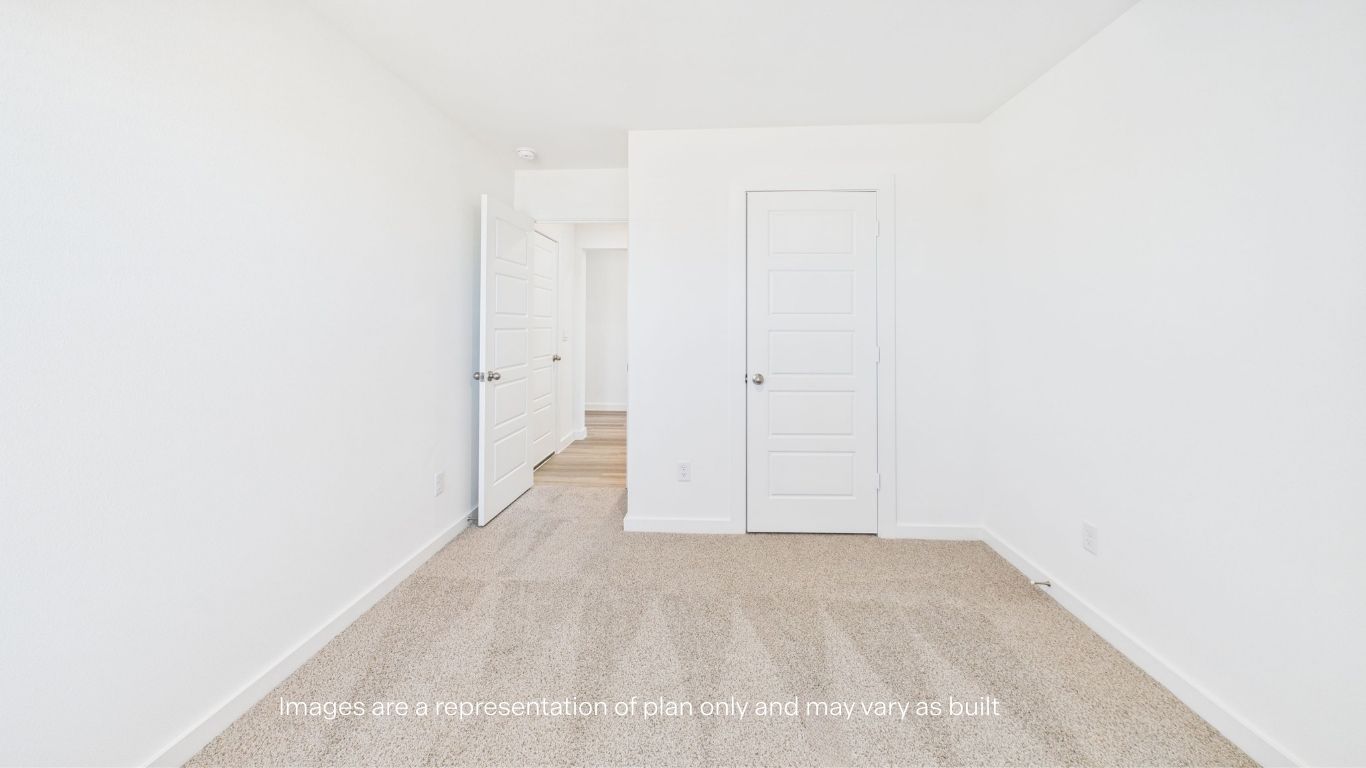Guest bedroom with plush carpet floor and spacious closet