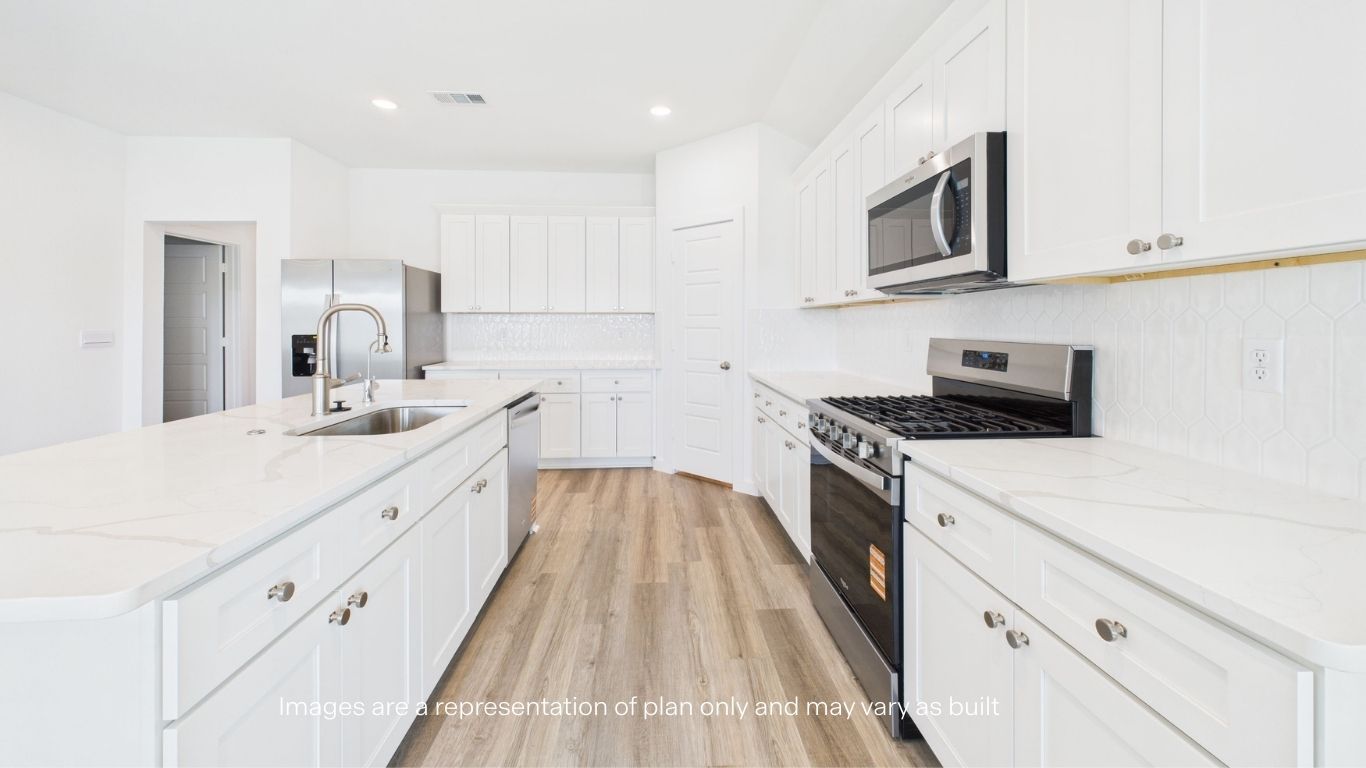 Open concept kitchen with stainless steel appliances, shaker style cabinets, and elevated finishes