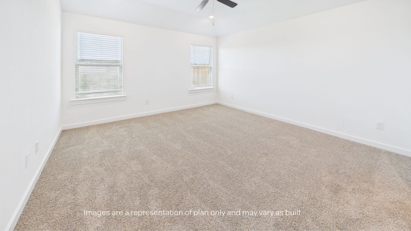 Primary bedroom with plush carpet floors and light allowing double windows