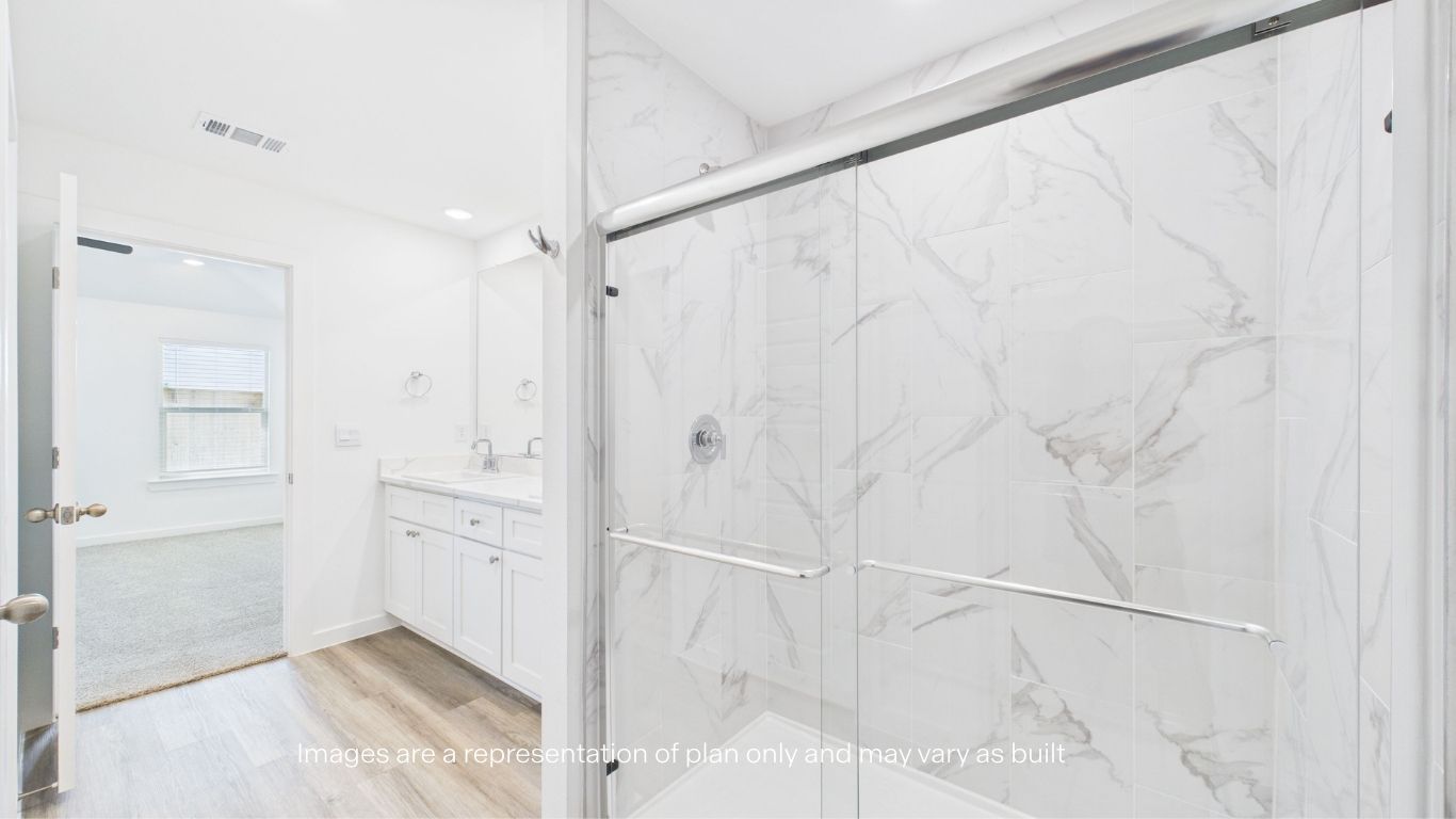 Primary bathroom with built in vanity and luxurious shower