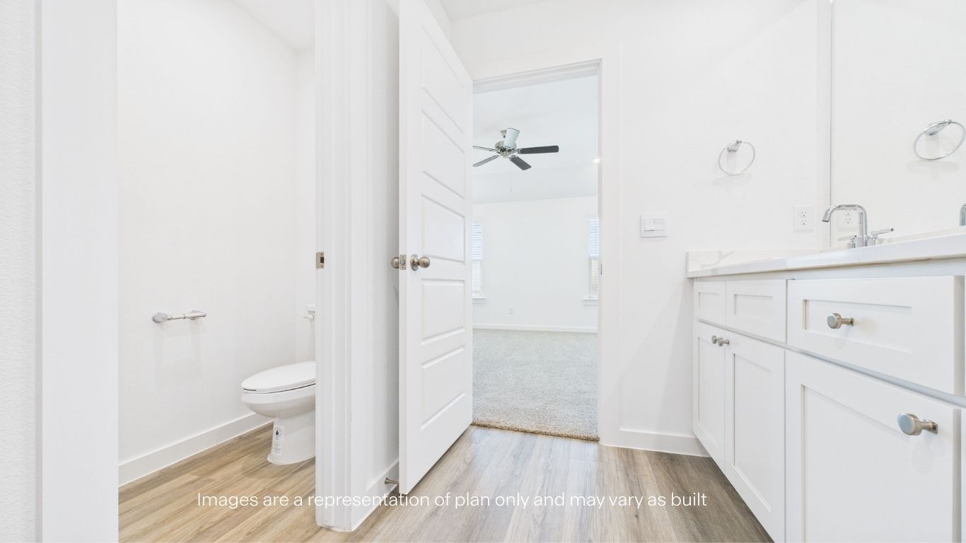Primary bathroom with built in vanity and private water room
