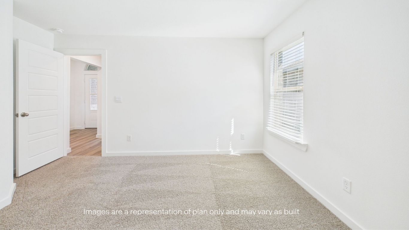 Guest bedroom with side window and plush carpet