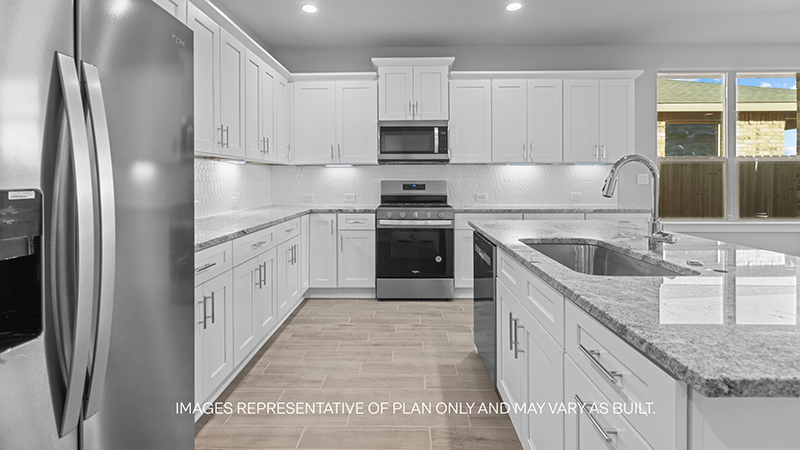 kitchen with marble counter, white cabinets, and stainless steel appliances