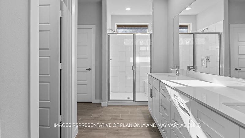 primary bath with walk in shower and dual sink with vanity