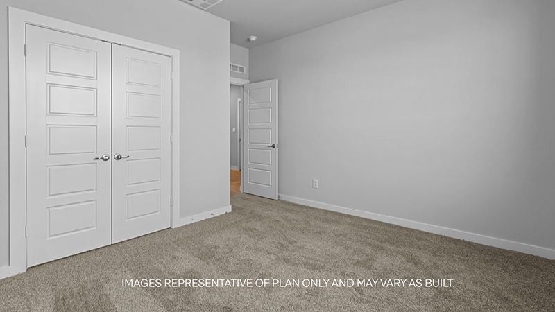 guest bed with plush carpet and spacious closet