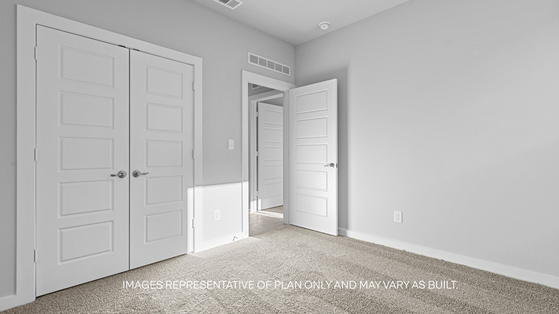 guest bed with plush carpet and spacious closet