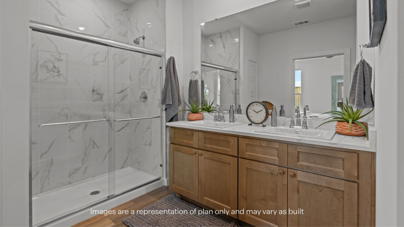 Primary bathroom with built in vanity and luxurious shower