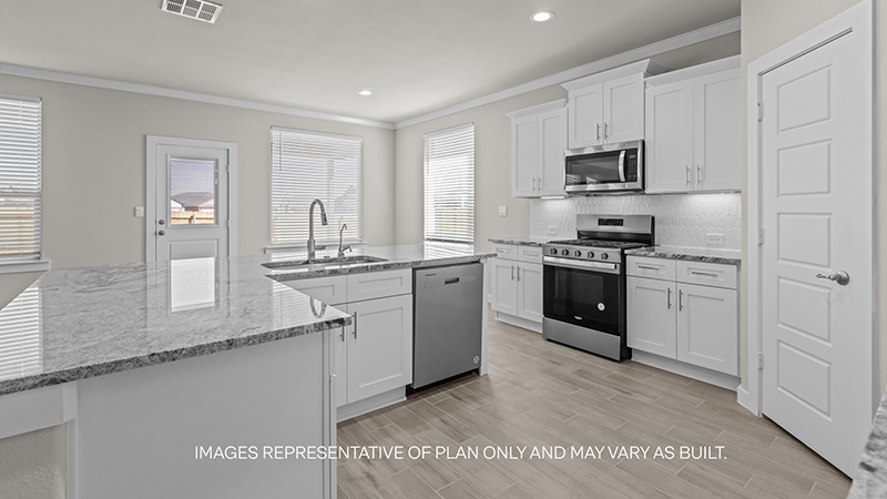 kitchen with spacious island, quartz counters and stainless-steel appliances