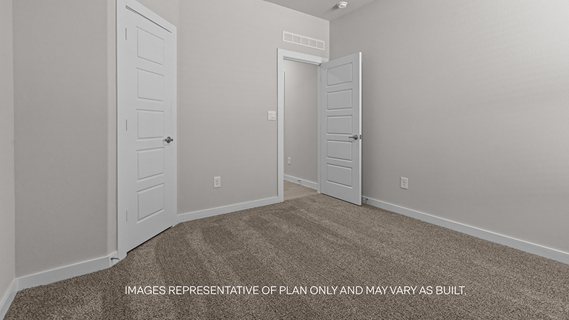 guest bedroom with plush carpet and spacious closet