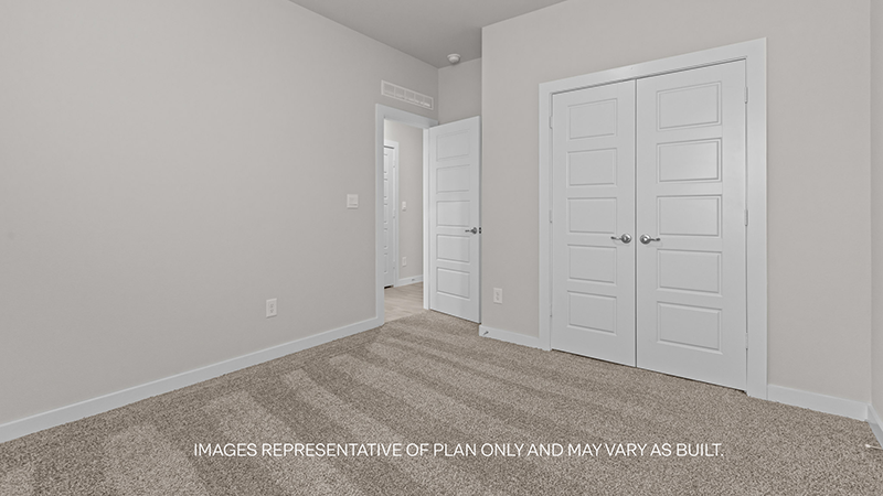 guest bedroom with plush carpet and spacious closet