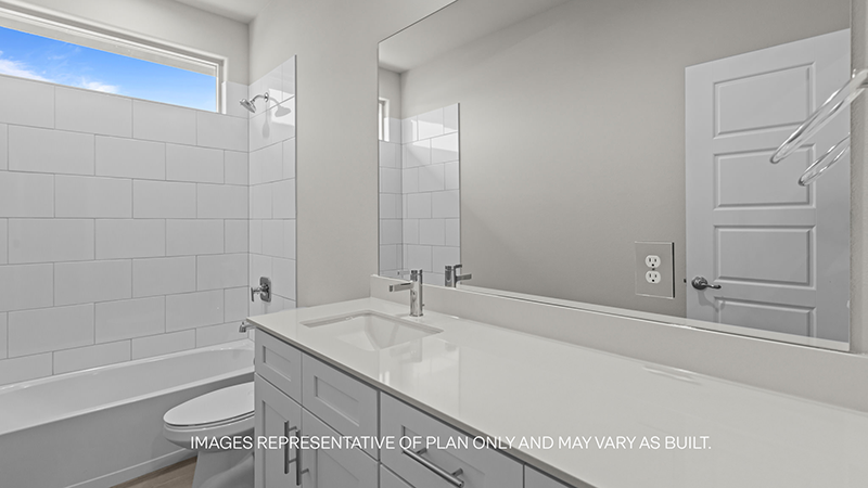 guest bathroom with single sink, vanity and bathtub shower combo