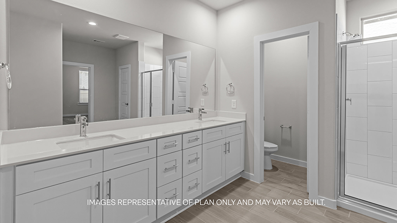 primary bathroom with dual sink, vanity and walk in shower