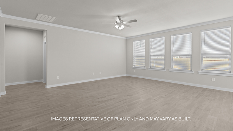 Open airy living room with vinyl plank flooring and windows overlooking the backyard