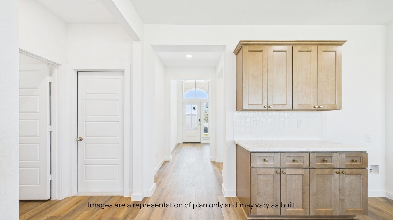End of entrance hallway into kitchen with Extra Built in storage in kitchen and countertop area