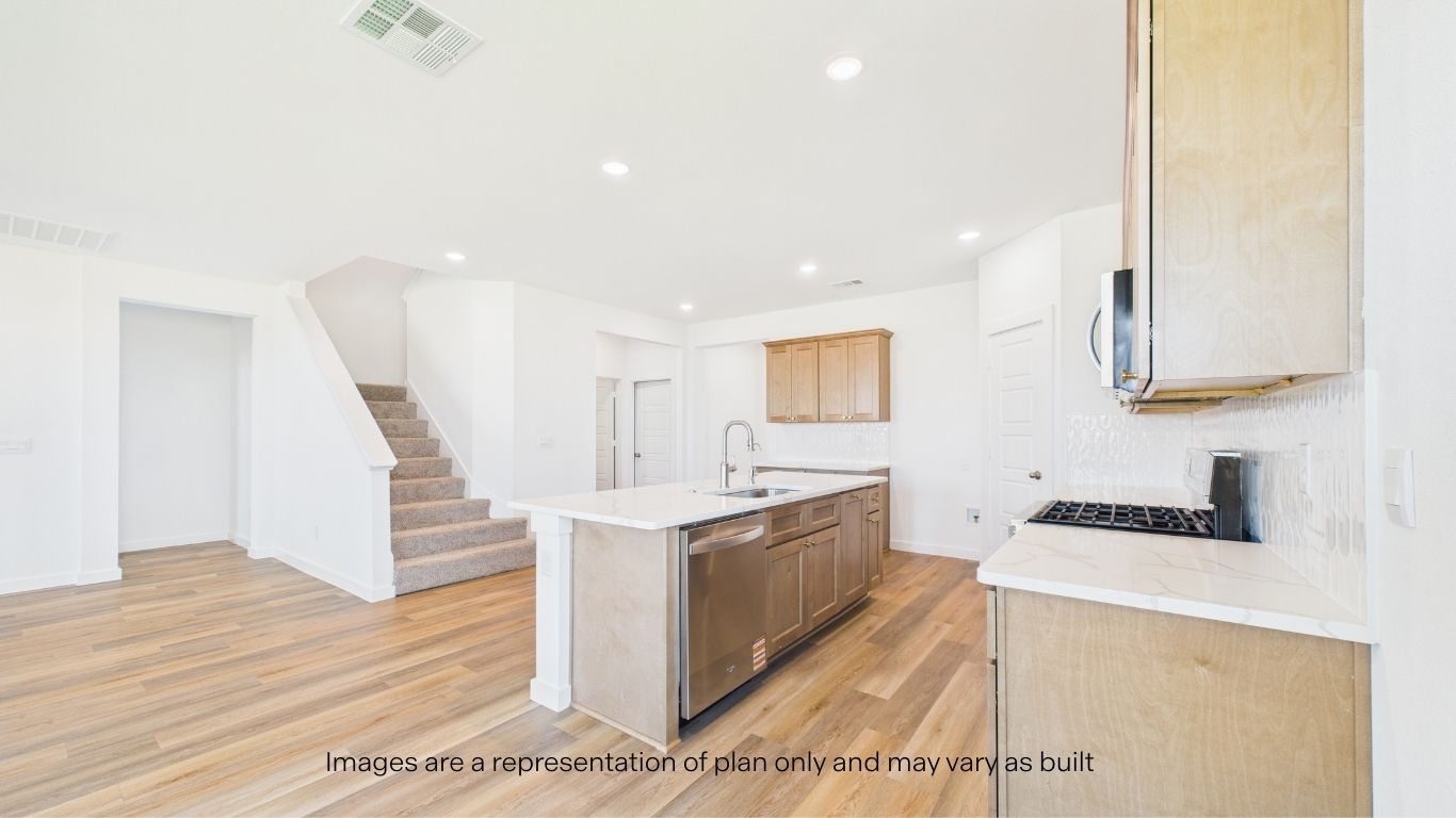 Open concept Kitchen overlooking to living room area and staircase