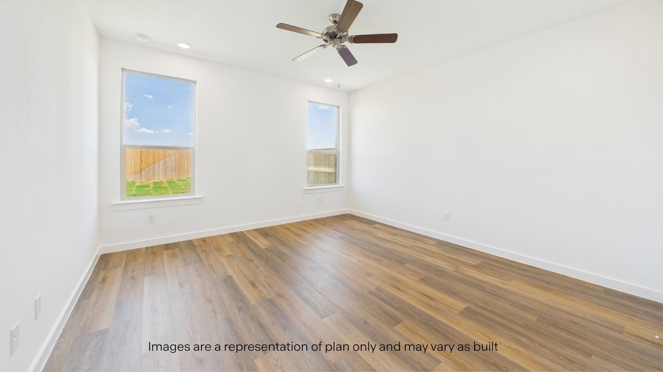Primary bedroom with plush carpet floors and light allowing double windows
