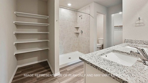 Large walk-in shower and storage space in primary bathroom