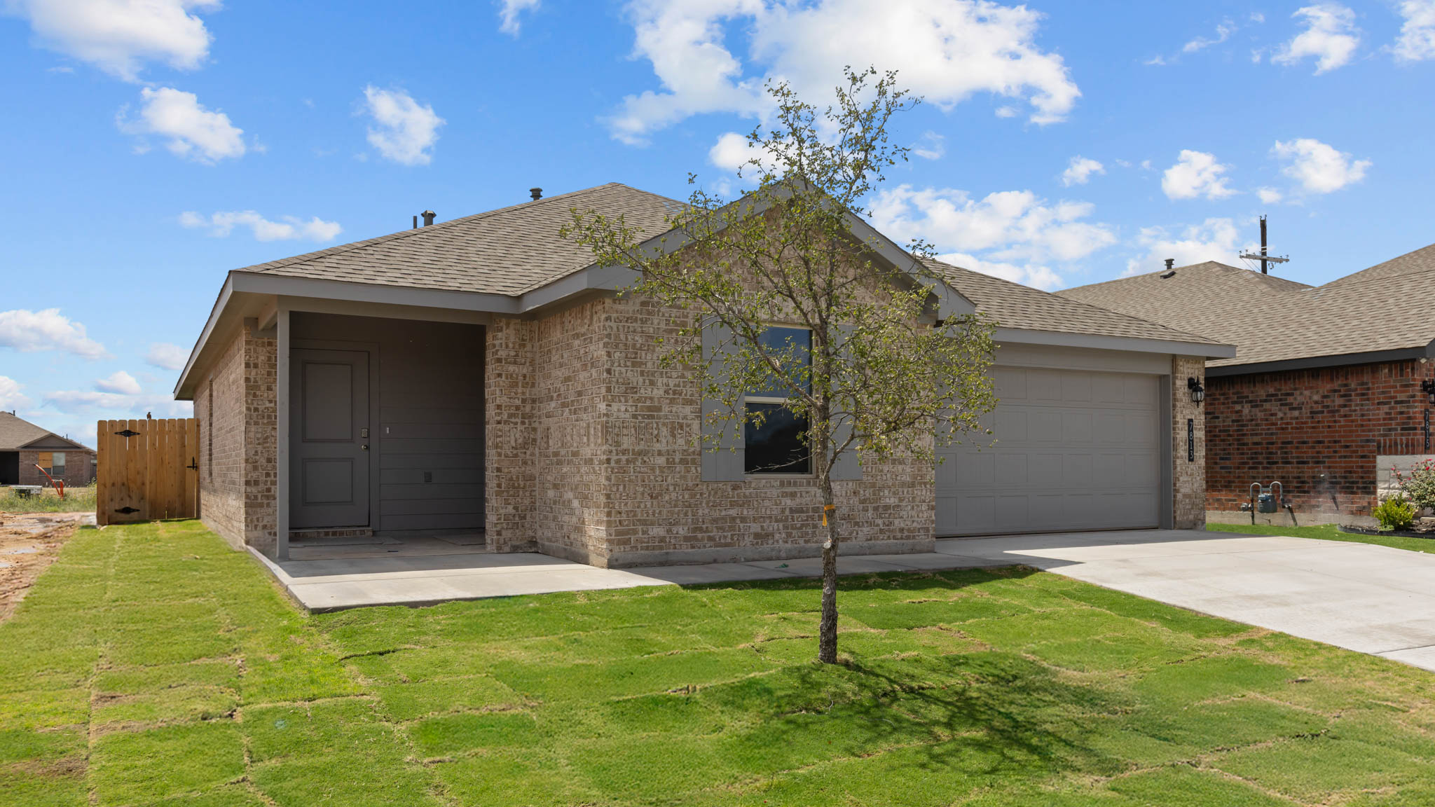 Side view of single story timeless brick home