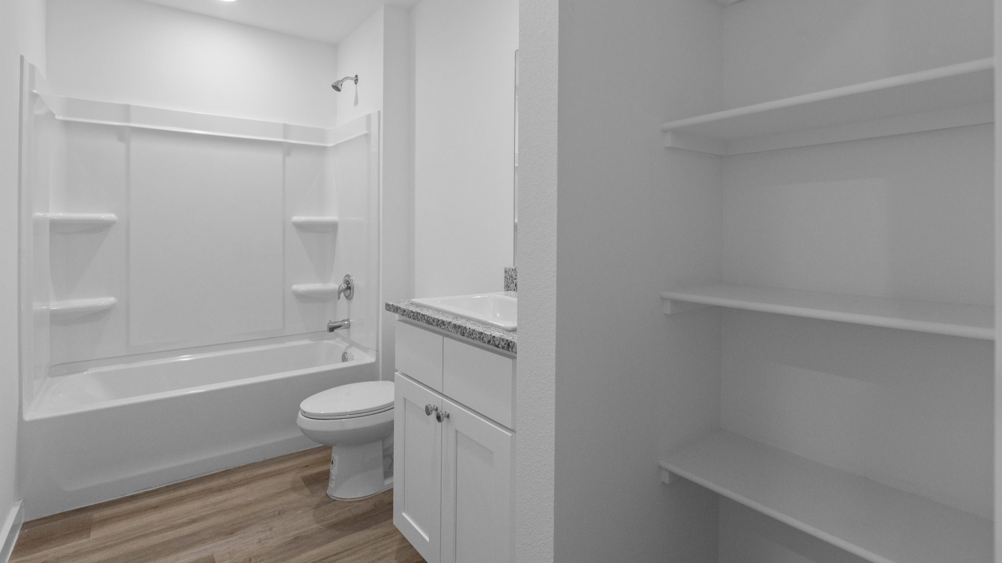 Guest bathroom with built in vanity and combination bathtub shower