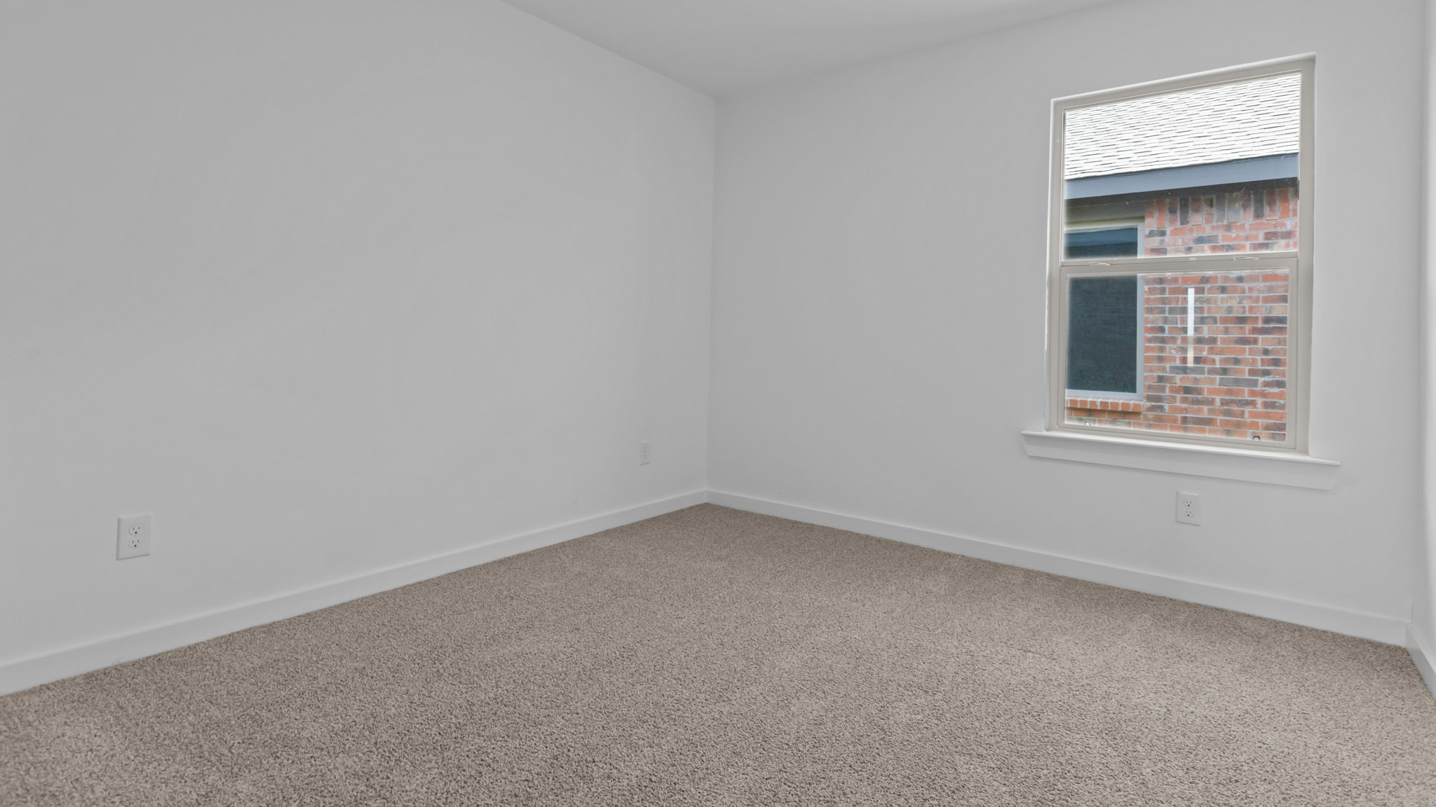 Guest bedroom 2 with side window and plush carpet floor