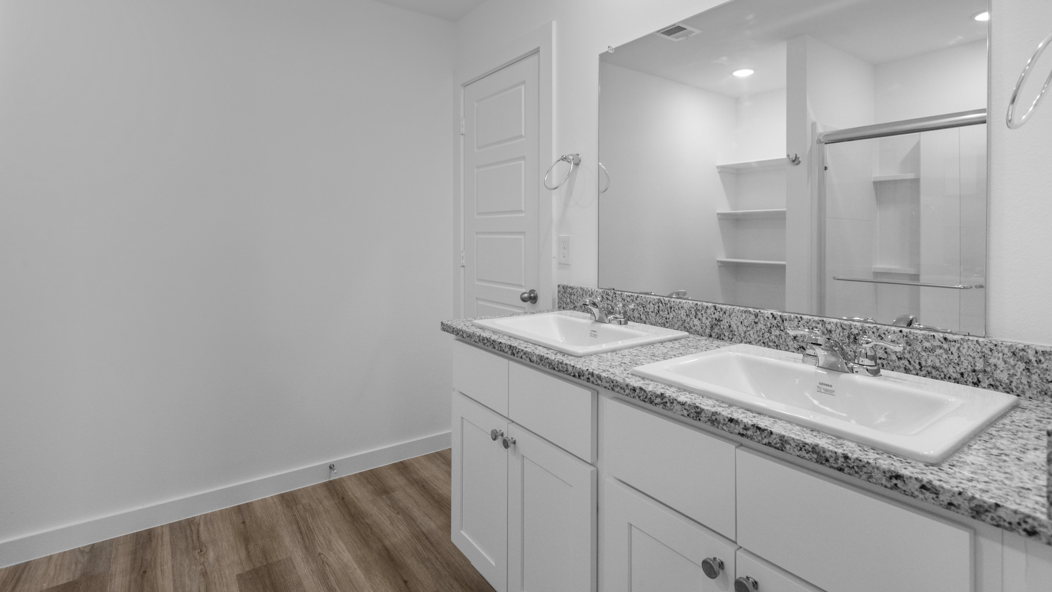 Primary bathroom with built in vanity and luxurious shower