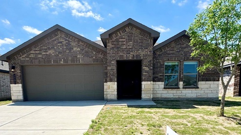 Single Story home with brick, stone, covered patio and 2 car garage