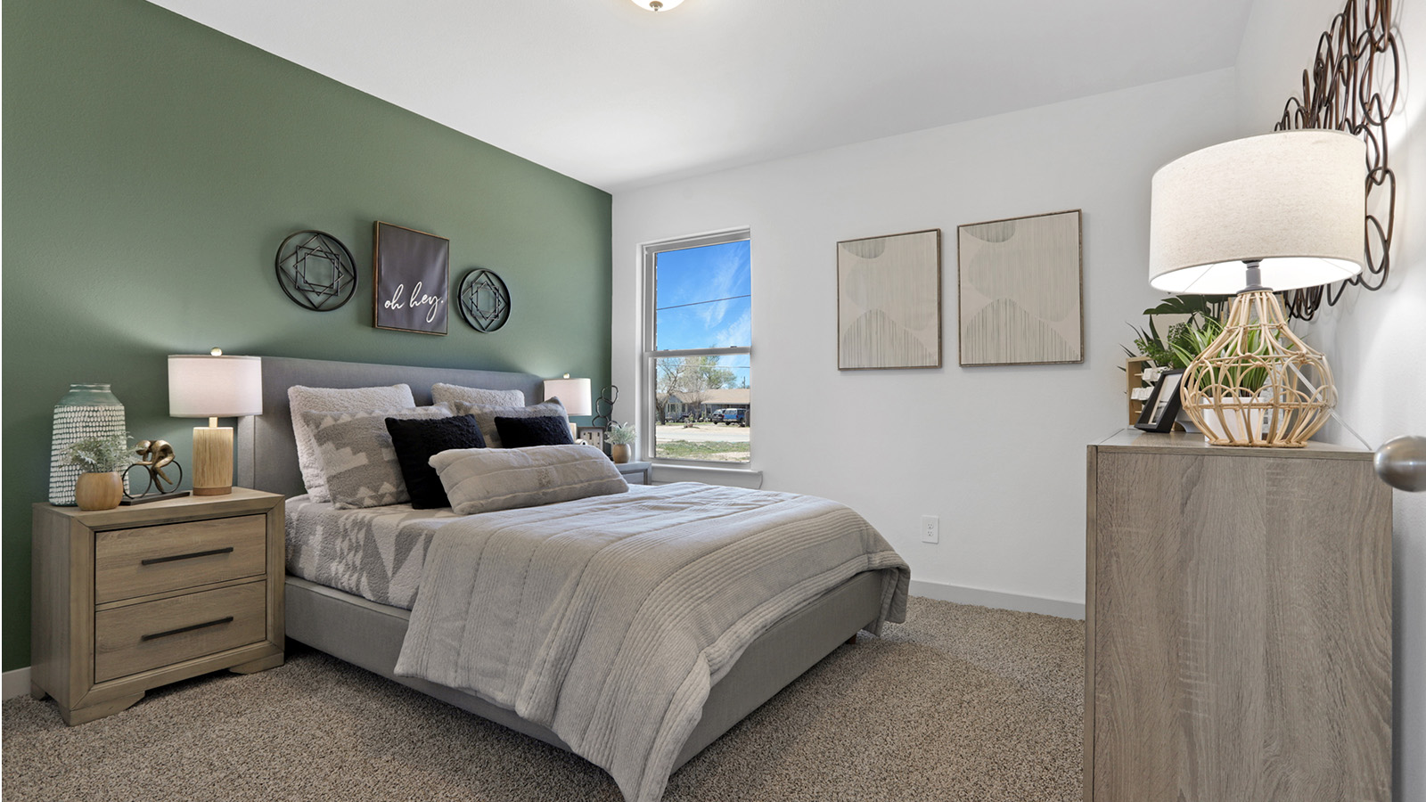 Guest bedroom with plush carpet, windows and decor