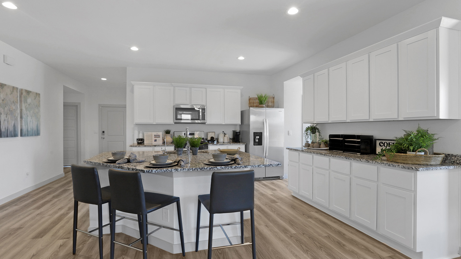 Kitchen with breakfast bar. island and white cabinets