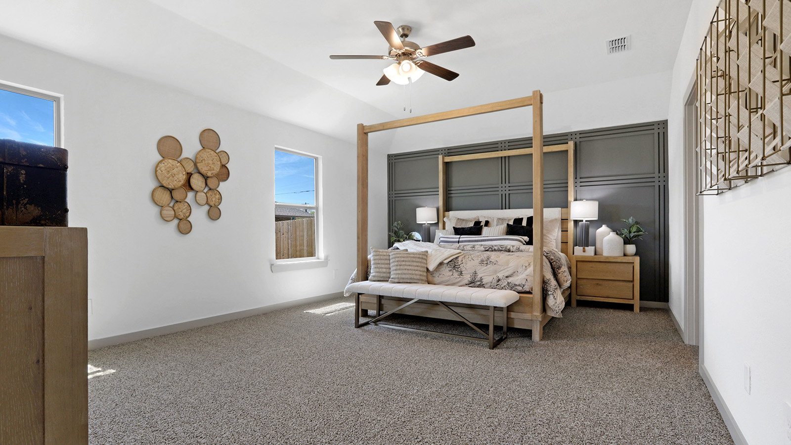 Primary bedroom with plush carpet, white interior and attached bathroom