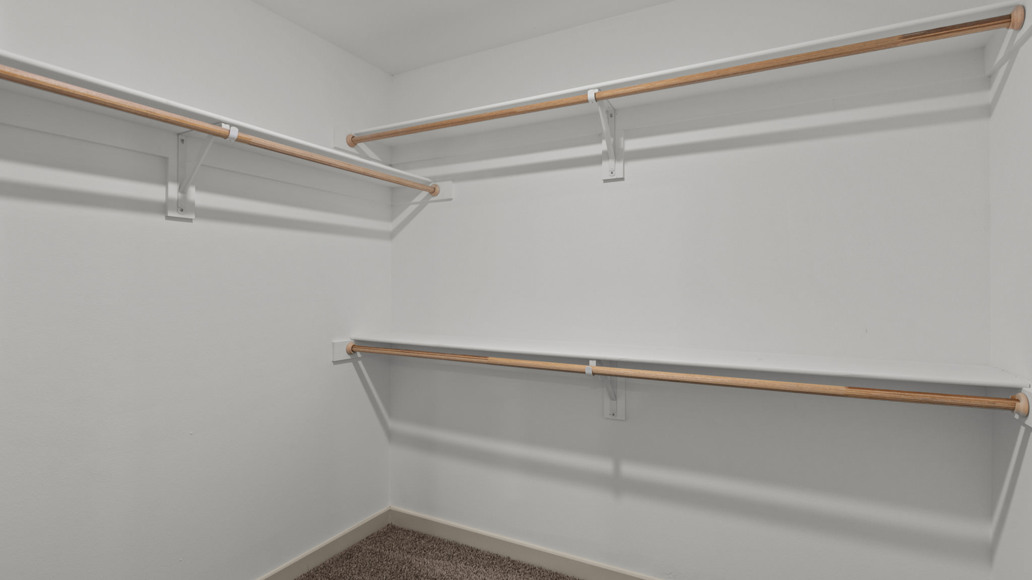 Primary Walk-in closet with wooden shelving