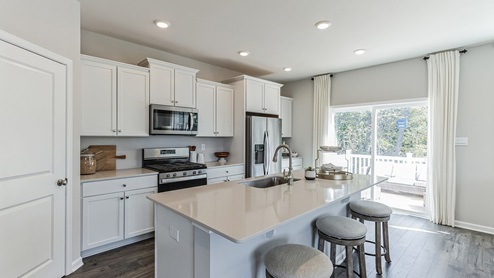 crofotn white kitchen with island and stainless-steel appliances