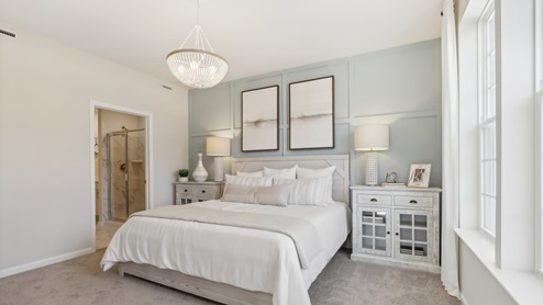first floor main bedroom with beige carpet